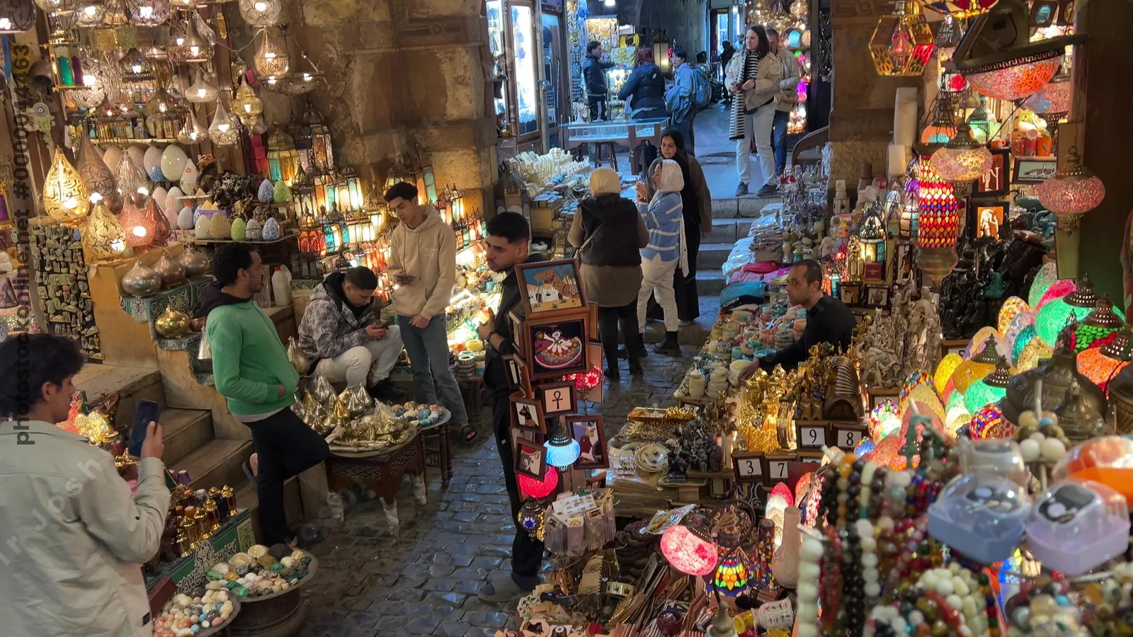 Cairo, Egypt - Feb 12, 2025: Brightly lit lamps and lanterns displayed in the bustling street market of Khan el-Khalili, the famous bazaar in historic Cairo.