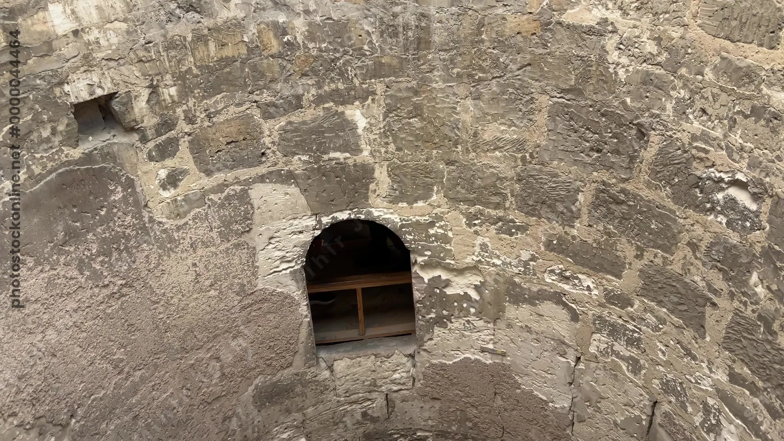 Alexandria, Egypt - Feb 13, 2025: Circular descent shaft inside the Catacombs of Kom El Shoqafa featuring spiral access and niches, part of the ancient Greco-Roman necropolis.