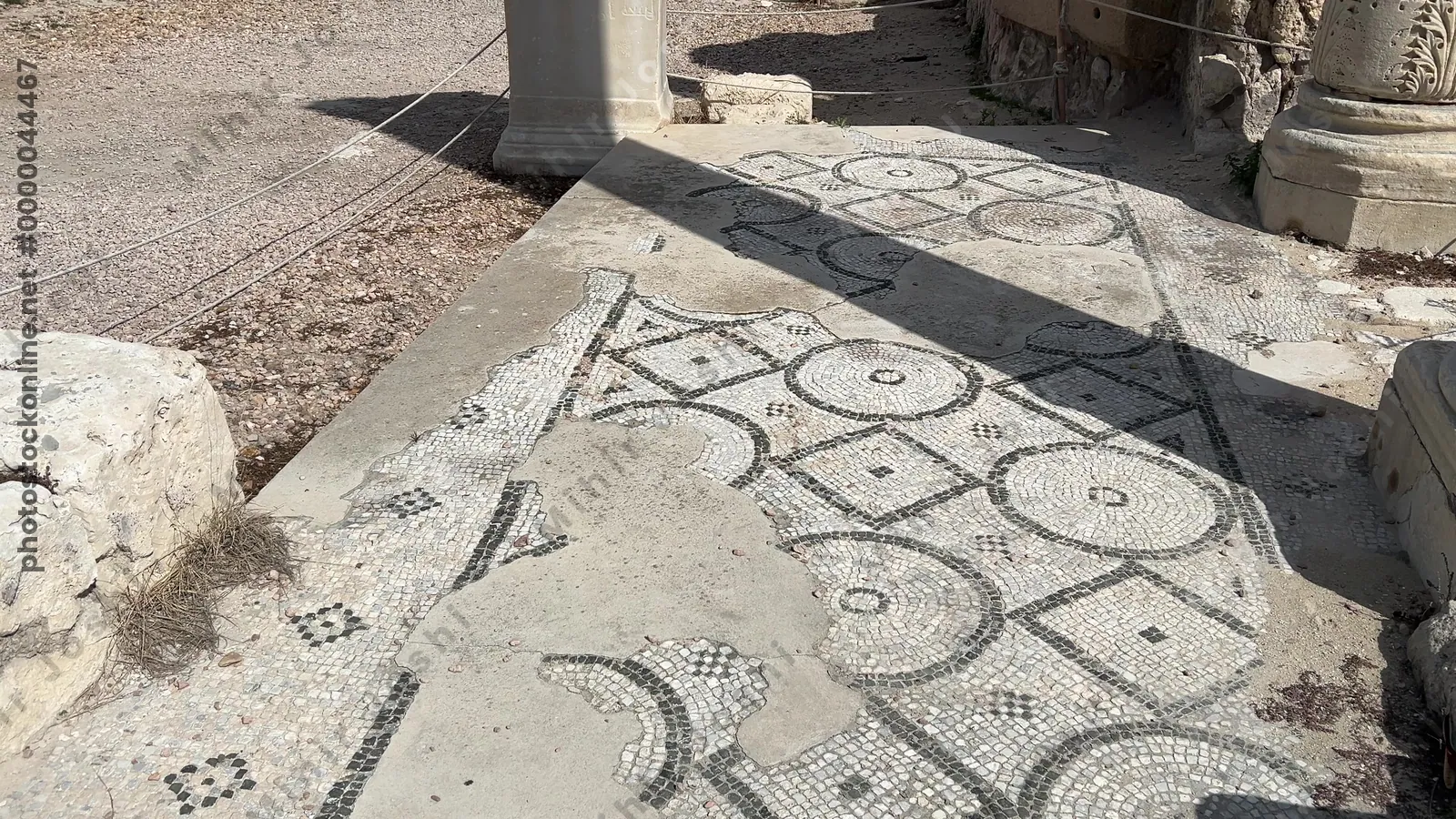 Alexandria, Egypt - Feb 13, 2025: Roman theatre ruins at Kom El-Dikka archaeological site with preserved mosaic floor, stone seating, and column remains.