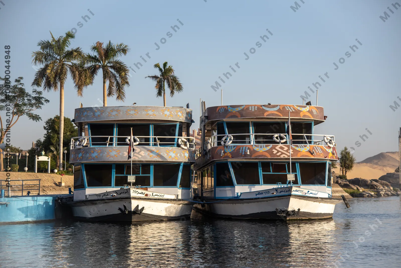 Pyramisa Island, Aswan, Egypt - Feb 7, 2025:  Ferry boats docked at Pyramisa Island on the Nile River in Egypt, offering transport and scenic views.
